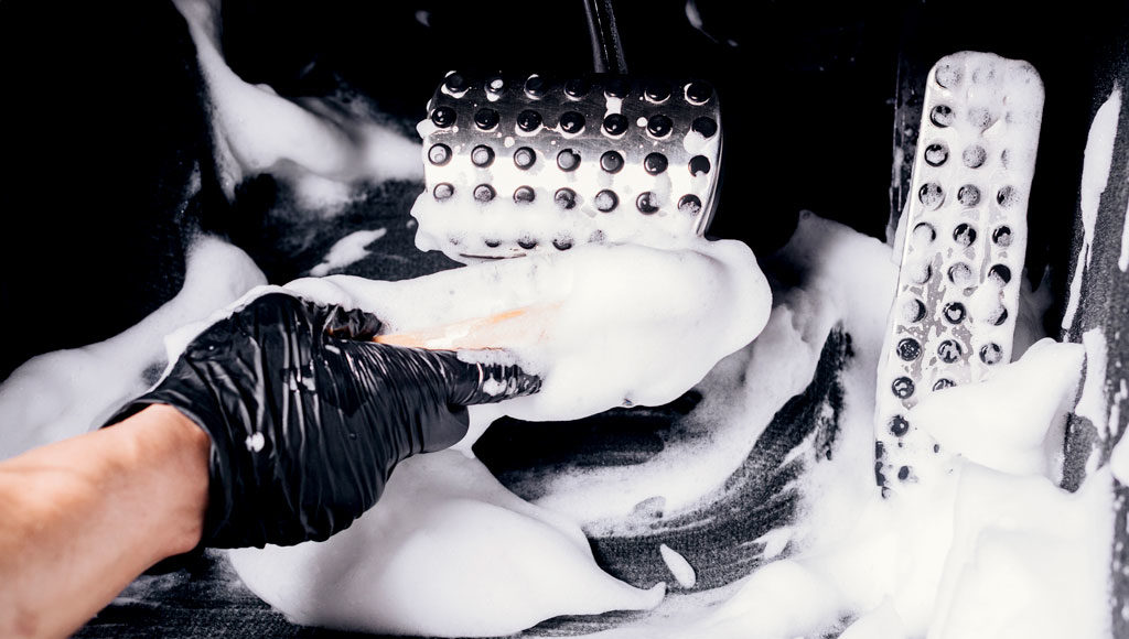 Professional cleaning foot petals of Porsche vehicle